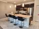 Modern kitchen with a large island, stainless appliances and stylish pendant lighting at 1058 Splash Shot Pl, Davenport, FL 33896