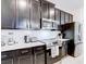 The kitchen features espresso cabinetry, stainless appliances, and white subway tile backsplash at 1058 Splash Shot Pl, Davenport, FL 33896