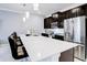 This kitchen features bar stool seating at a large island, stainless appliances and pendant lights at 1058 Splash Shot Pl, Davenport, FL 33896