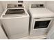 Laundry room featuring front load washer and dryer on marble floors at 1058 Splash Shot Pl, Davenport, FL 33896