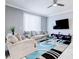 The spacious living room has a modern ceiling fan and stylish furniture at 1058 Splash Shot Pl, Davenport, FL 33896