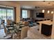 This modern living room has direct access to dining area and pool at 1058 Splash Shot Pl, Davenport, FL 33896