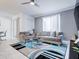 Living room is complete with tile flooring, a ceiling fan and modern decor at 1058 Splash Shot Pl, Davenport, FL 33896
