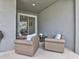 Outdoor patio features three armchairs, small coffee table, and sliding glass doors at 1058 Splash Shot Pl, Davenport, FL 33896