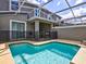 Exterior pool features turquoise water and a screen enclosure at 1058 Splash Shot Pl, Davenport, FL 33896