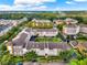 Birds eye view of a condo community with lush trees, manicured lawns, and multiple buildings at 1231 Wright Cir # 108, Kissimmee, FL 34747