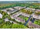 Aerial view of a condo community with various buildings, mature trees, landscaping and parking at 1231 Wright Cir # 108, Kissimmee, FL 34747