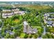 An aerial view of a condominium community featuring a pool, a nearby lake, and clubhouse at 1231 Wright Cir # 108, Kissimmee, FL 34747
