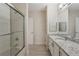 Bright bathroom showcasing granite countertops, large mirror, tiled floors and glass shower at 1231 Wright Cir # 108, Kissimmee, FL 34747