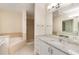 Bathroom showcasing granite countertops, double sinks, a bathtub, and a shower at 1231 Wright Cir # 108, Kissimmee, FL 34747