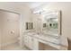 Bathroom featuring double sinks, granite countertops, and a large framed mirror at 1231 Wright Cir # 108, Kissimmee, FL 34747