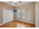 Bedroom featuring hardwood floors, shutters, closet and a TV at 1231 Wright Cir # 108, Kissimmee, FL 34747