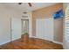 Bedroom featuring hardwood floors, closet and an ensuite bathroom at 1231 Wright Cir # 108, Kissimmee, FL 34747
