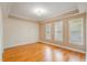 Spacious room with tray ceiling, hardwood floors and three large windows at 1231 Wright Cir # 108, Kissimmee, FL 34747