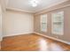 Spacious room with tray ceiling, hardwood floors and two large windows at 1231 Wright Cir # 108, Kissimmee, FL 34747