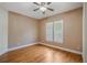Bedroom featuring hardwood floors, ceiling fan, and plantation shutters at 1231 Wright Cir # 108, Kissimmee, FL 34747