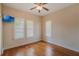 Bedroom features hardwood floors, plantation shutters, and a TV at 1231 Wright Cir # 108, Kissimmee, FL 34747