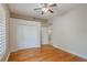 Bedroom with hardwood floors, ceiling fan, and closet at 1231 Wright Cir # 108, Kissimmee, FL 34747