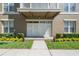 Charming entryway with large glass doors and well-kept garden landscaping at 1231 Wright Cir # 108, Kissimmee, FL 34747