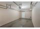 Two car garage with overhead storage racks and white pedestrian door at 1231 Wright Cir # 108, Kissimmee, FL 34747