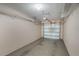 Spacious two-car garage with overhead storage racks and white door at 1231 Wright Cir # 108, Kissimmee, FL 34747