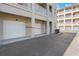 Exterior view of a garage with white doors in a condo building, offering convenient parking at 1231 Wright Cir # 108, Kissimmee, FL 34747