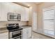 Modern kitchen featuring white cabinets, granite counters and stainless steel appliances at 1231 Wright Cir # 108, Kissimmee, FL 34747