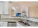 Granite countertops and stainless steel appliances create a sleek, modern kitchen at 1231 Wright Cir # 108, Kissimmee, FL 34747