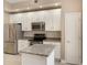 Modern kitchen with stainless steel appliances and white cabinets and an island at 1231 Wright Cir # 108, Kissimmee, FL 34747