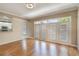 Bright living room featuring hardwood floors and elegant French doors at 1231 Wright Cir # 108, Kissimmee, FL 34747