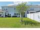 Spacious backyard with a lush green lawn, patios, and a white privacy fence creating a serene outdoor space at 12379 Turtle Grass Dr, Orlando, FL 32824