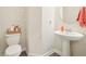 Powder room featuring pedestal sink and Disney-themed decor at 12379 Turtle Grass Dr, Orlando, FL 32824