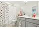 Bathroom featuring a shower with a polka dot curtain and a gray vanity at 12379 Turtle Grass Dr, Orlando, FL 32824