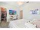 Bright bedroom with a work space, closet and a bed with white grid pattern bedding at 12379 Turtle Grass Dr, Orlando, FL 32824