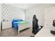 Bedroom with a triangle accent wall and a gaming setup with blue chair at 12379 Turtle Grass Dr, Orlando, FL 32824