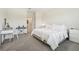 Well-lit bedroom showcasing neutral tones, carpet flooring, and coordinated decor with a desk at 12379 Turtle Grass Dr, Orlando, FL 32824