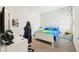 Bedroom with a blue and white triangle accent wall and a gaming setup at 12379 Turtle Grass Dr, Orlando, FL 32824