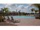 Resort-style community pool with lounge chairs and a covered seating area at 12379 Turtle Grass Dr, Orlando, FL 32824