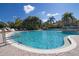 Community pool with a waterfall feature and ample space for relaxation and recreation at 12379 Turtle Grass Dr, Orlando, FL 32824