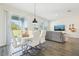 Bright dining area with modern table, stylish chairs, and sliding glass doors to the outdoor space at 12379 Turtle Grass Dr, Orlando, FL 32824