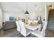 Open-concept dining area with modern table and chairs flowing into the living area and kitchen at 12379 Turtle Grass Dr, Orlando, FL 32824
