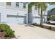 Well-kept townhome exterior with a two-car garage, complemented by neat landscaping and a driveway at 12379 Turtle Grass Dr, Orlando, FL 32824