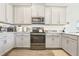 Updated kitchen with stainless appliances, quartz countertops, stylish cabinets, and subway tile backsplash at 12379 Turtle Grass Dr, Orlando, FL 32824