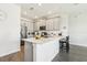 Well-lit kitchen with stainless steel appliances, quartz countertops, and modern barstool seating at 12379 Turtle Grass Dr, Orlando, FL 32824