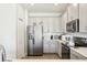 Bright kitchen featuring stainless steel appliances and light gray cabinetry at 12379 Turtle Grass Dr, Orlando, FL 32824