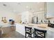Open kitchen with quartz countertops, stainless appliances, and barstool seating with a view to the living area at 12379 Turtle Grass Dr, Orlando, FL 32824