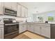 Beautiful kitchen with modern appliances, updated cabinets, and a view into the adjacent dining area at 12379 Turtle Grass Dr, Orlando, FL 32824