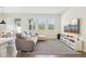 Spacious living room featuring a plush sofa, large windows, and a modern entertainment setup for relaxation at 12379 Turtle Grass Dr, Orlando, FL 32824