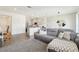 Cozy living space with open layout to the kitchen, featuring a comfortable sofa and stylish decor at 12379 Turtle Grass Dr, Orlando, FL 32824