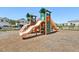 Well-maintained community playground with slides and climbing areas, surrounded by landscaping at 12379 Turtle Grass Dr, Orlando, FL 32824